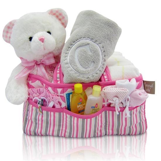 Our unique baby girl gifts include this diaper tote with personalized blankets, stuffed animals, and more.